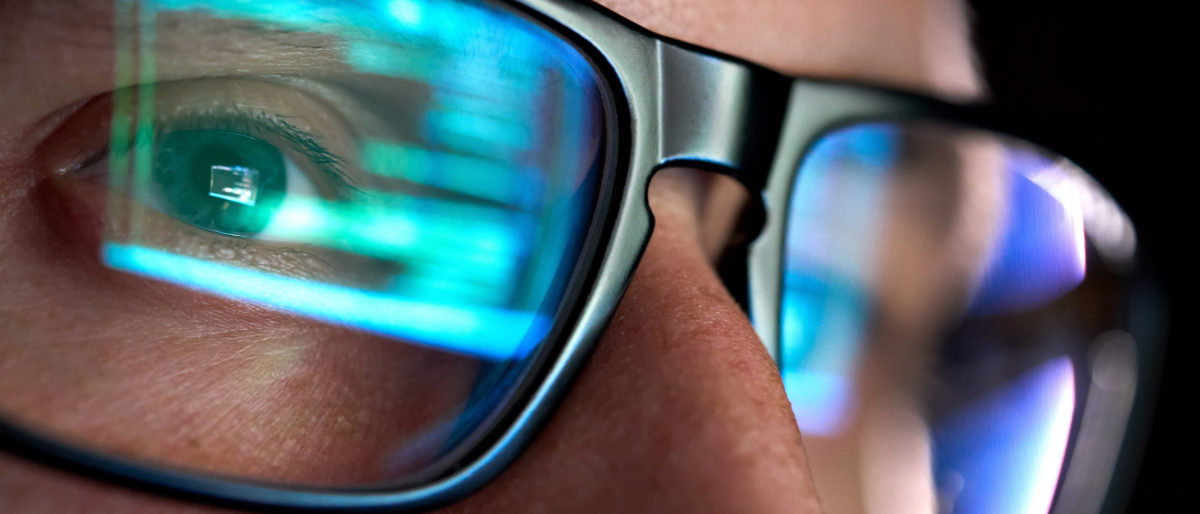 Close-up of human eyes with glasses.