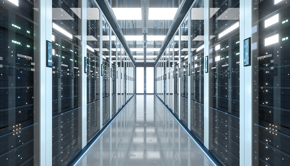 A modern data center corridor lined with black server racks, each with blue LED lights illuminated on both sides.